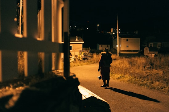 A security officer patrolling a quiet residential neighborhood on Mid-Vancouver Island at dusk.