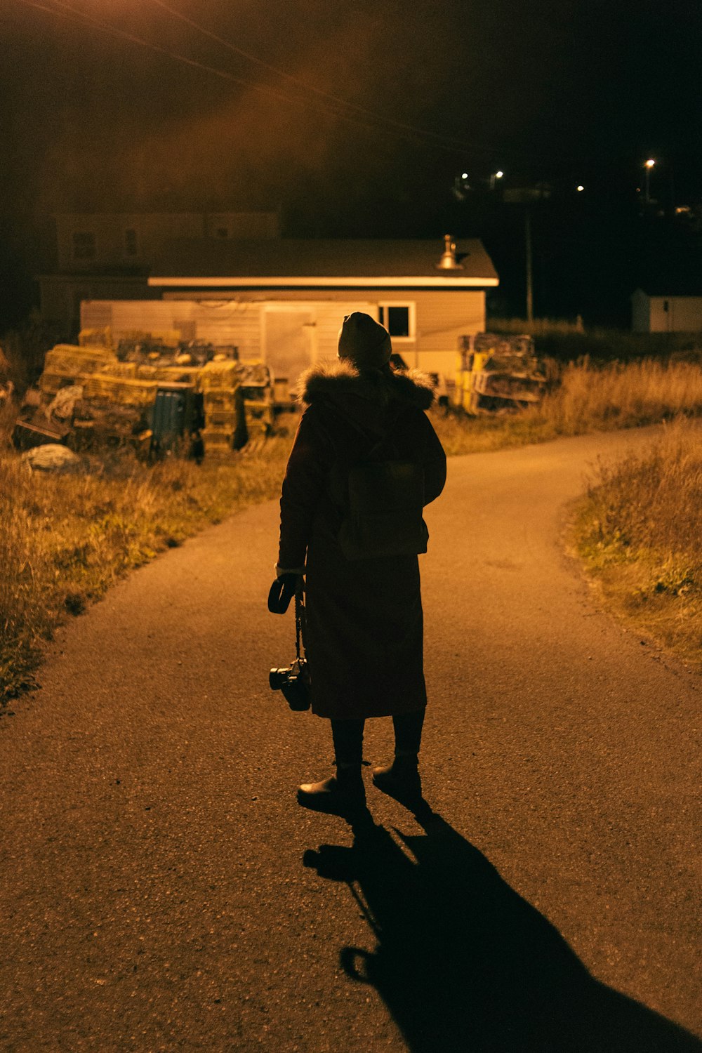 a person walking down a road at night