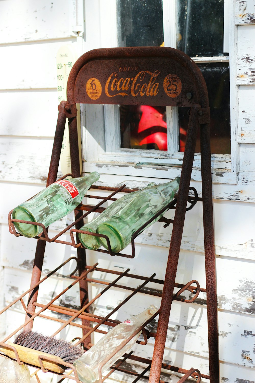 an old coca cola machine sitting outside of a building