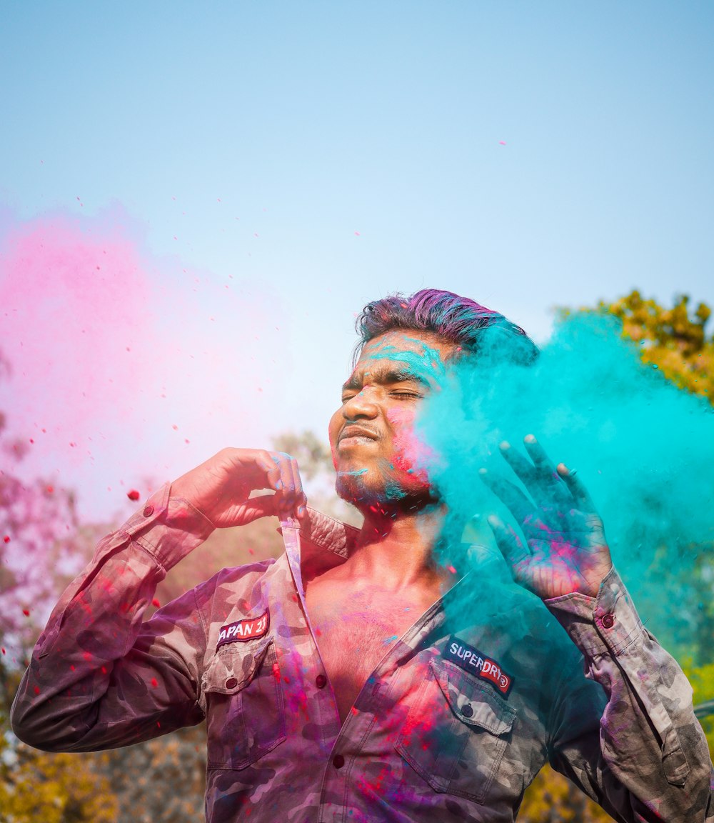 a man with blue and pink powder on his face