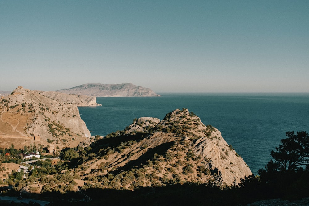 a view of a body of water with mountains in the background