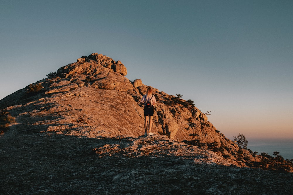 a person standing on top of a rocky mountain