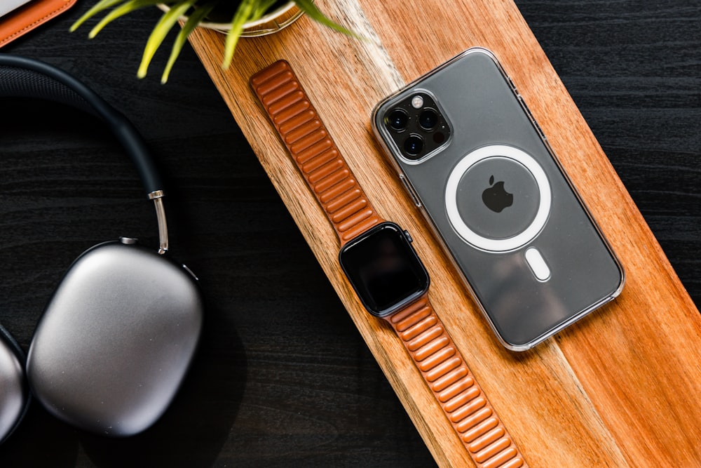 a pair of headphones and an iphone on a table