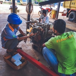 A technician performing tests on a truck engine.