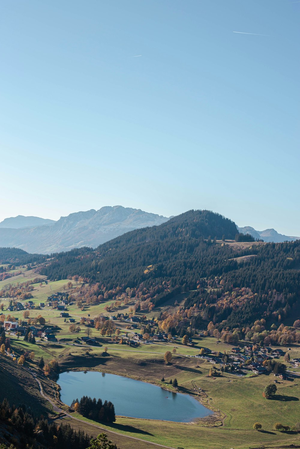 a scenic view of a valley with a lake in the foreground