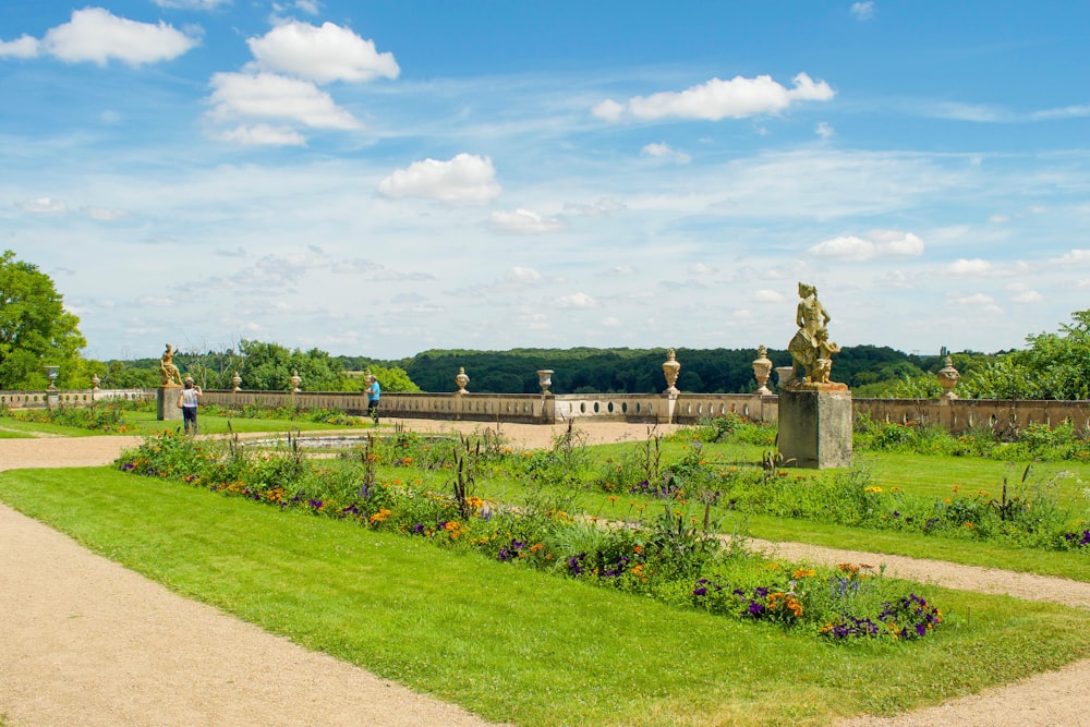 a garden with a statue in the middle of it