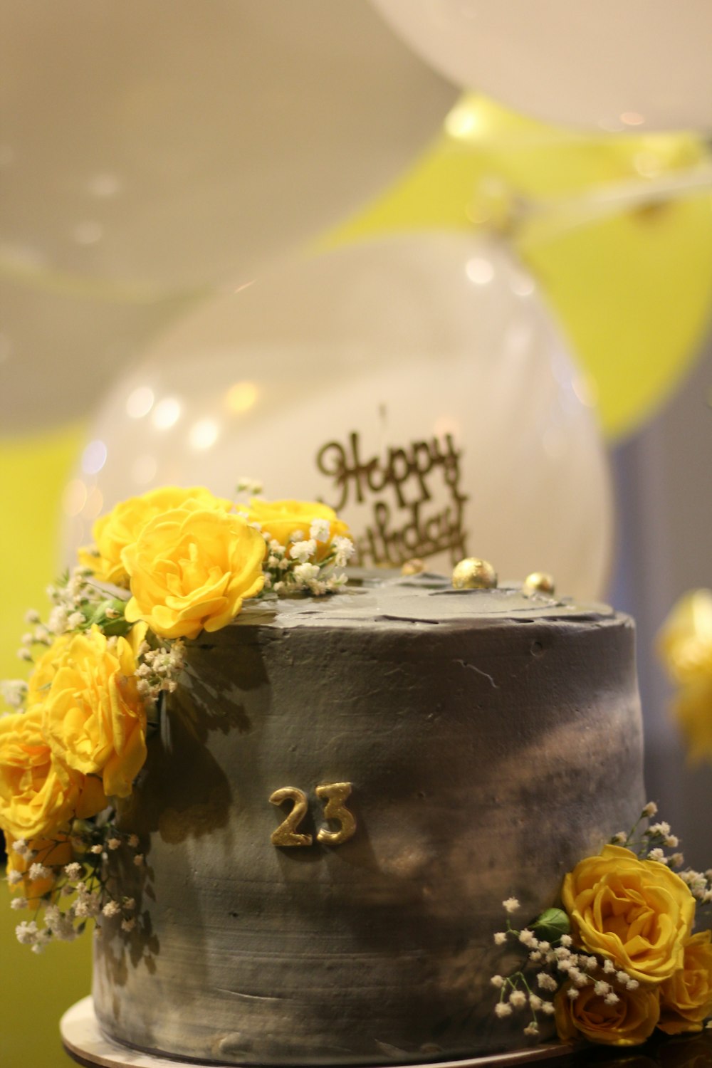 a birthday cake with yellow flowers on top of it