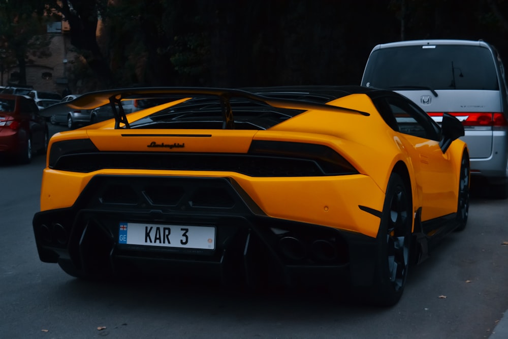 a yellow sports car parked on the side of the road