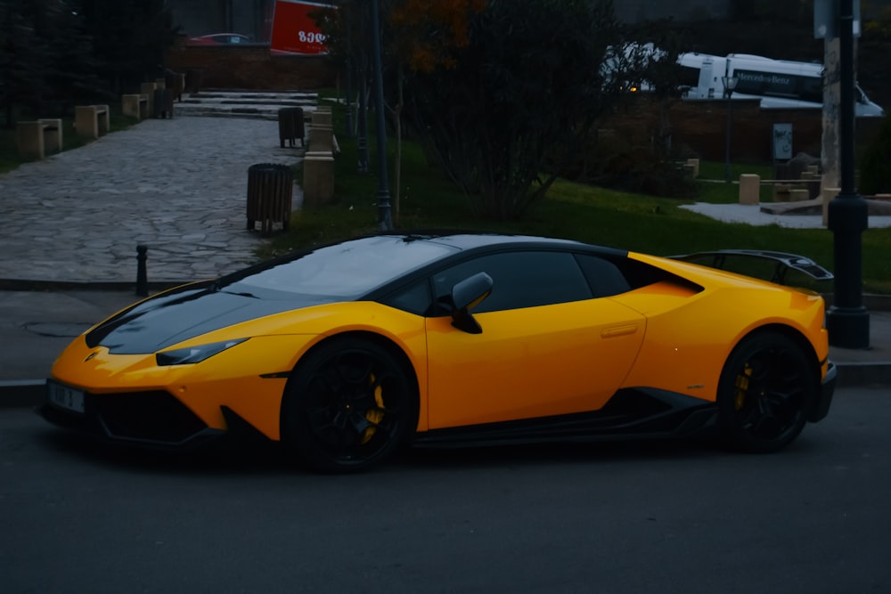 a yellow sports car parked on the side of the road