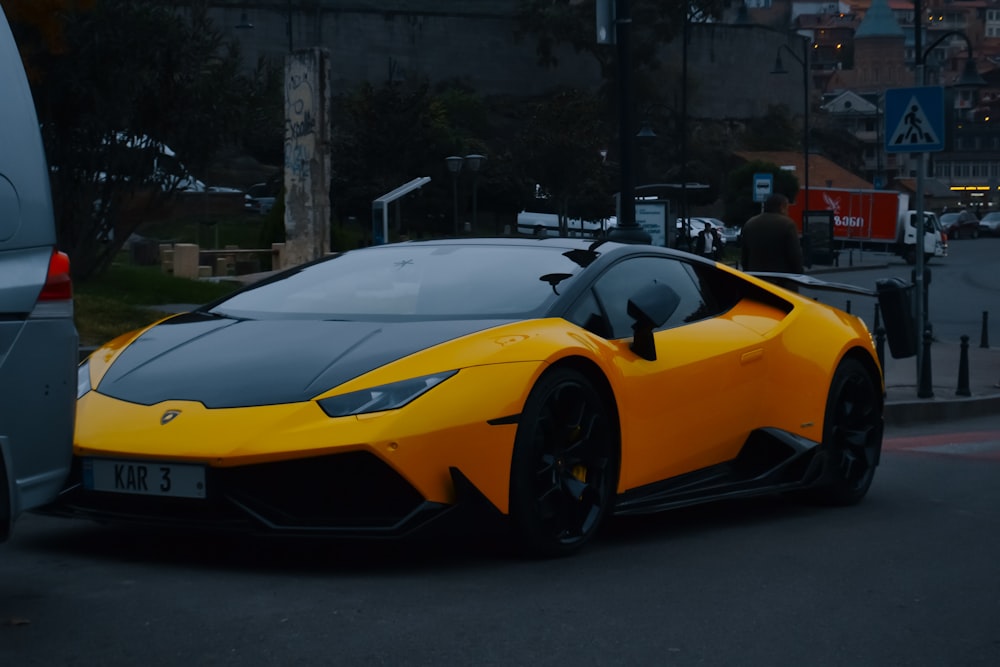 a yellow sports car parked on the side of the road