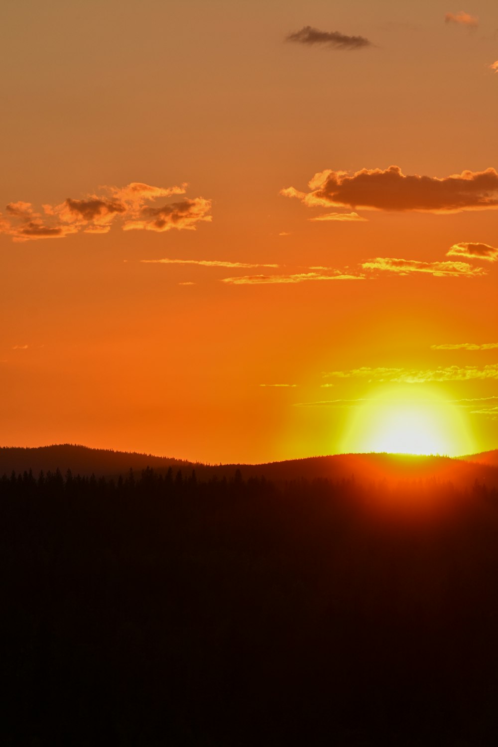 the sun is setting over a mountain range