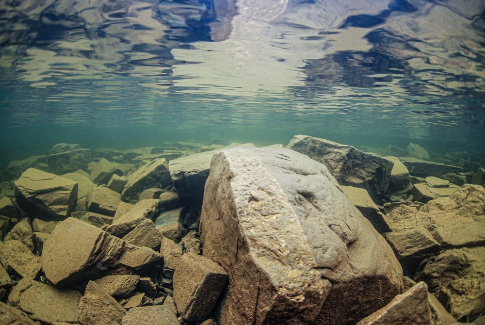 a large rock in the middle of a body of water