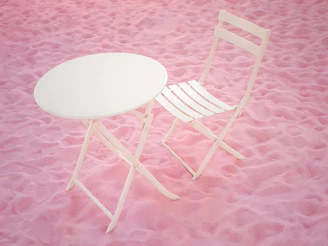 A sturdy white foldable table set up outdoors in Riyadh with a backdrop of modern buildings.