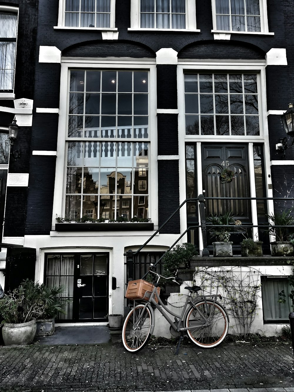 a bicycle parked in front of a black building