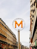 a street sign with the letter m on top of it