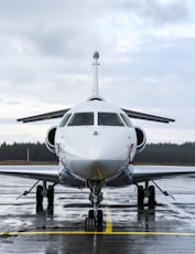 a white airplane sitting on top of an airport tarmac