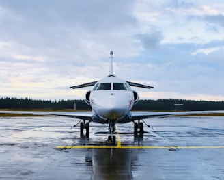 an airplane is parked on a wet runway