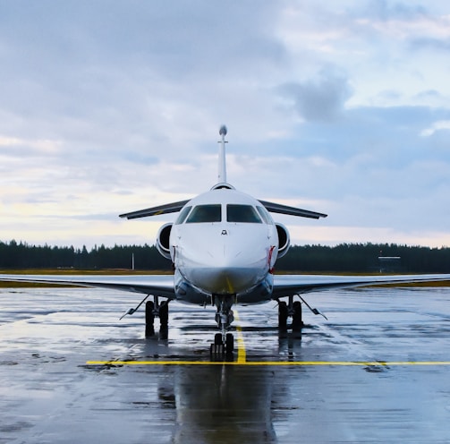 an airplane is parked on a wet runway