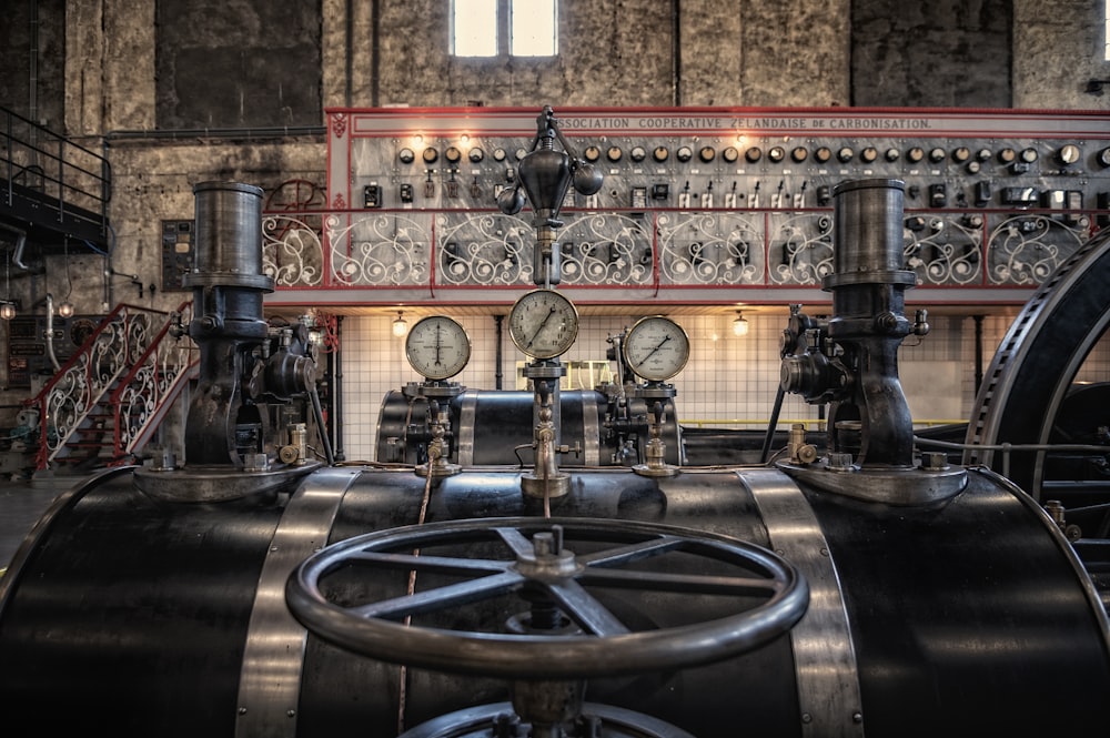 a large machine in a building with a clock on the front of it