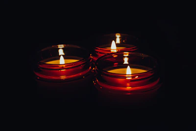 a group of lit candles sitting on top of a table
