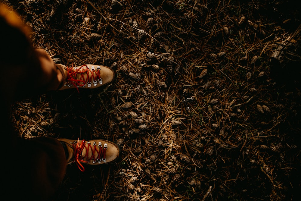 a person standing in the grass with their shoes on