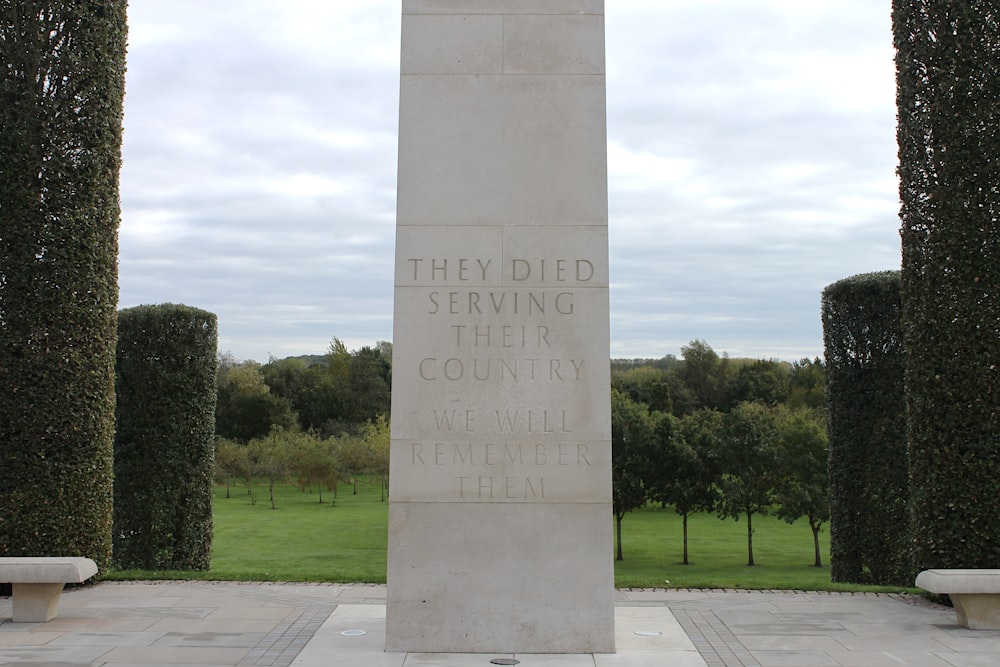 a monument in a park with trees in the background