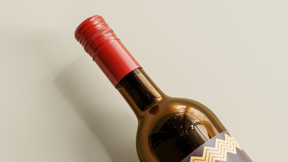 a bottle of wine with a red cap