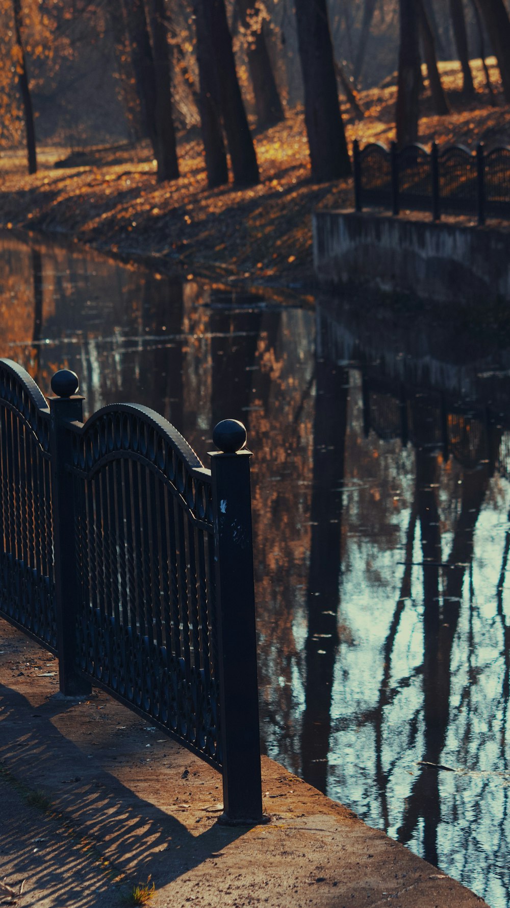 a park bench sitting next to a body of water