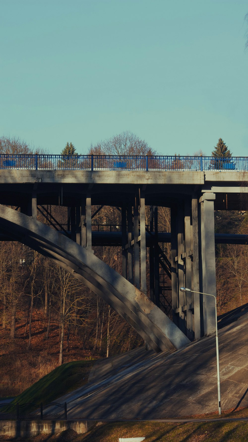 a bridge over a road with a train going over it