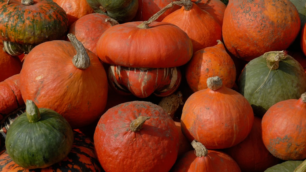 a pile of orange pumpkins sitting next to each other