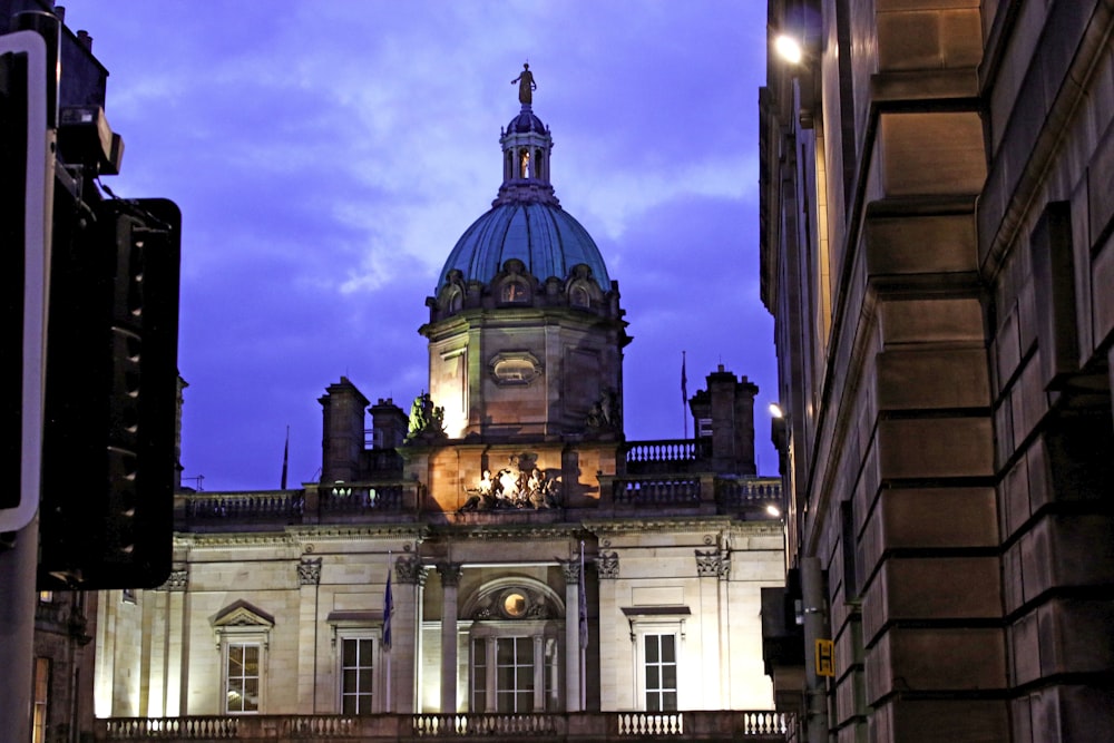 a tall building with a clock tower at night