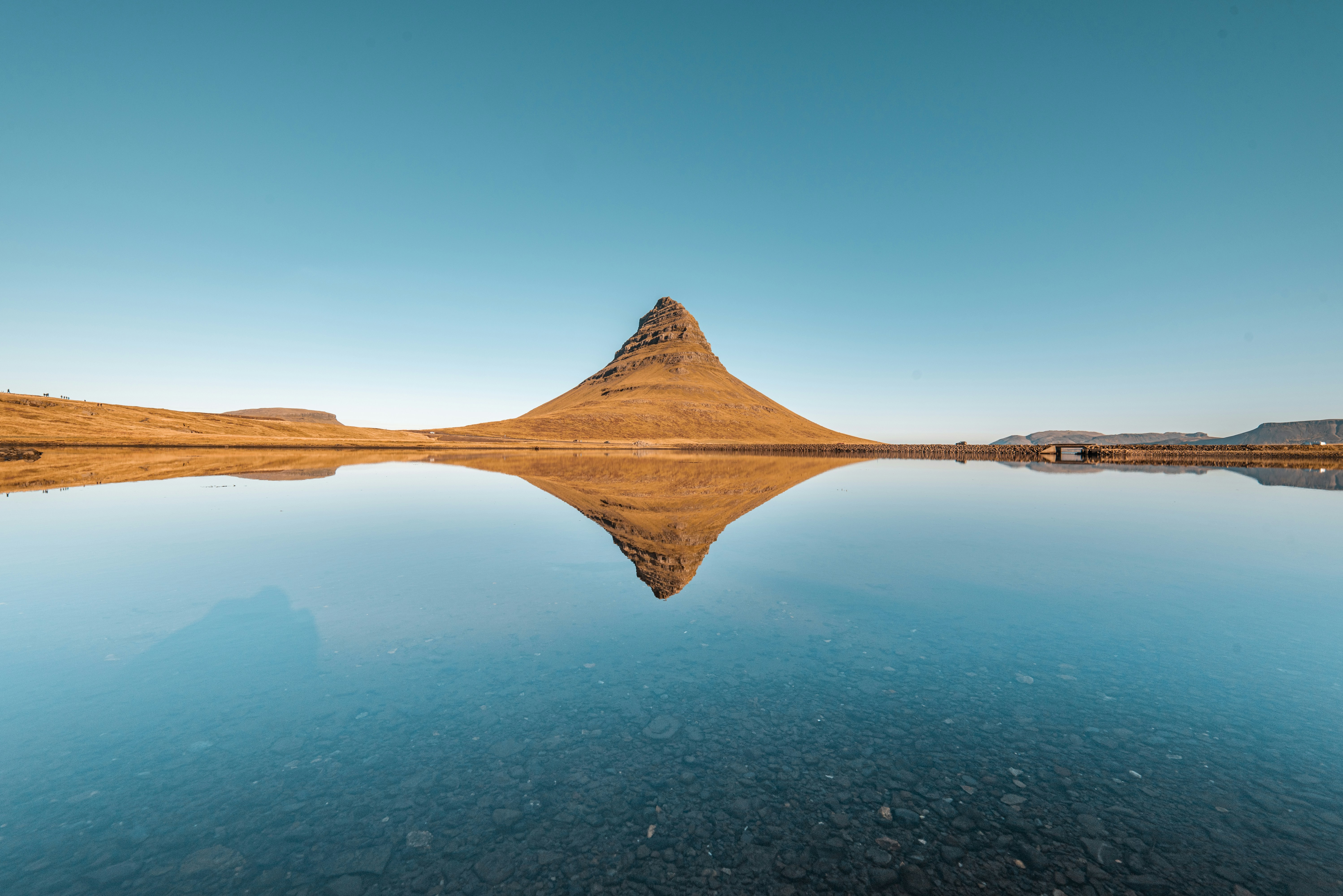 a mountain is reflected in the still water of a lake