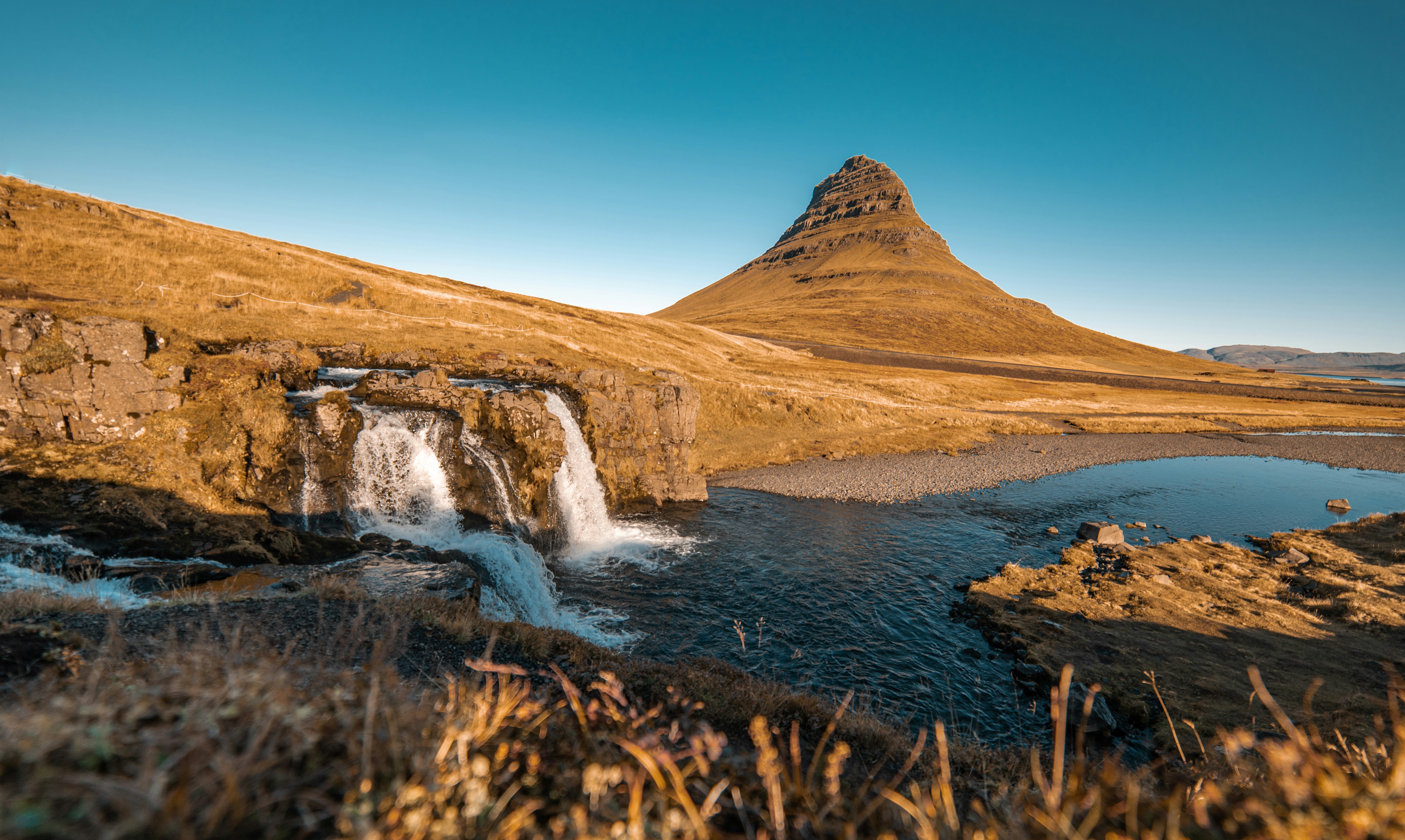a small waterfall in the middle of a field