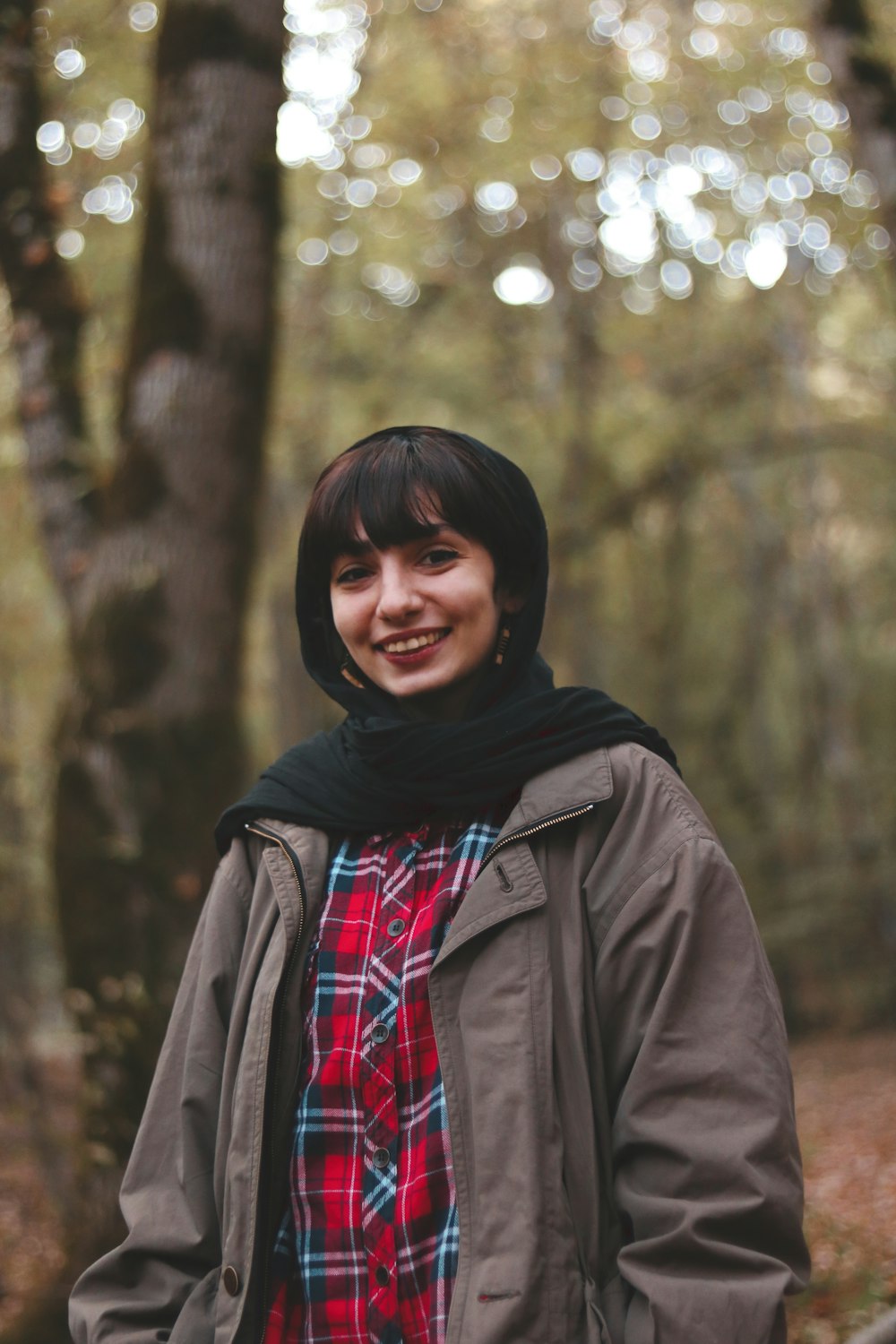 a woman standing in front of a forest