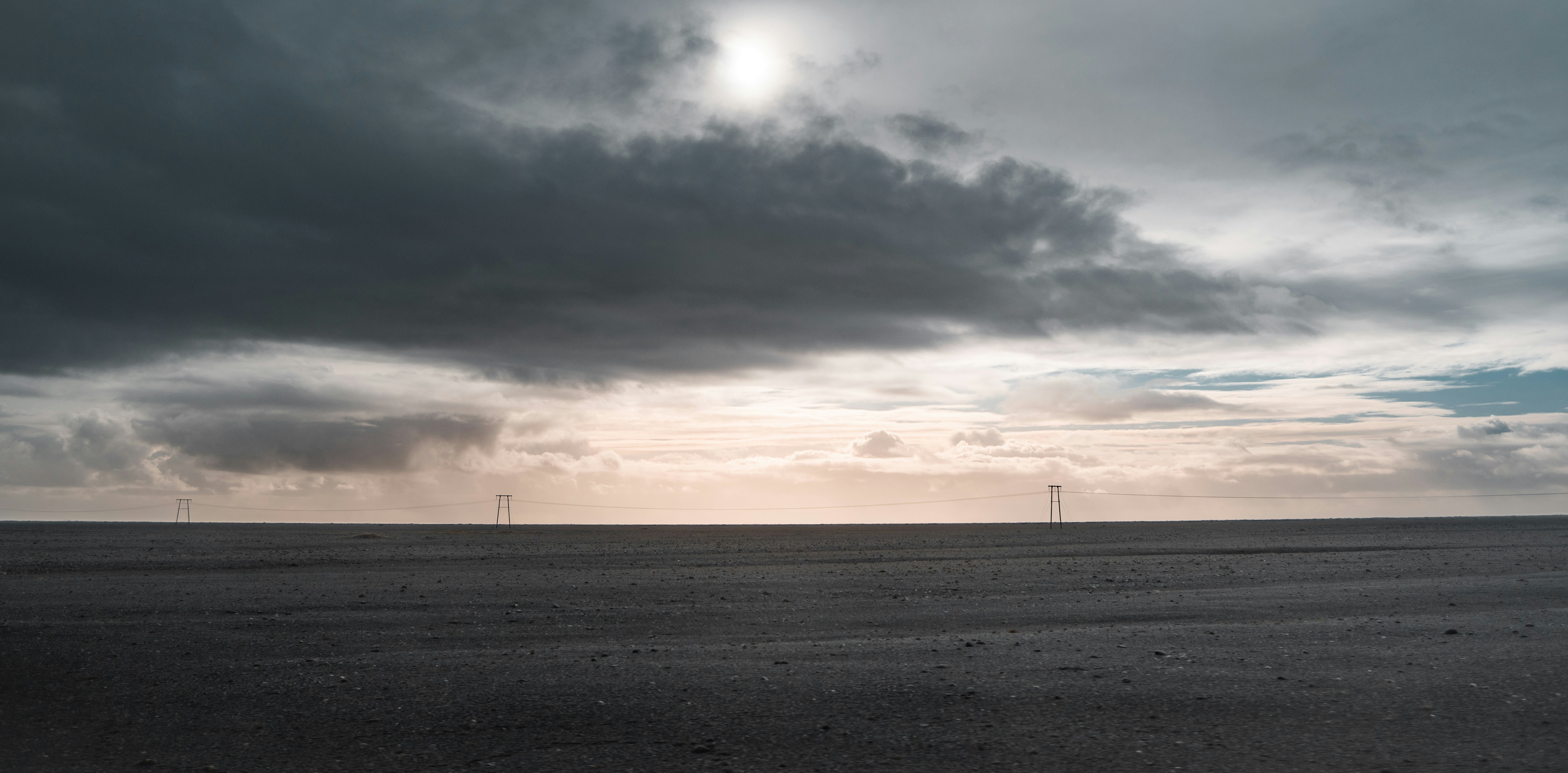 a large open field under a cloudy sky