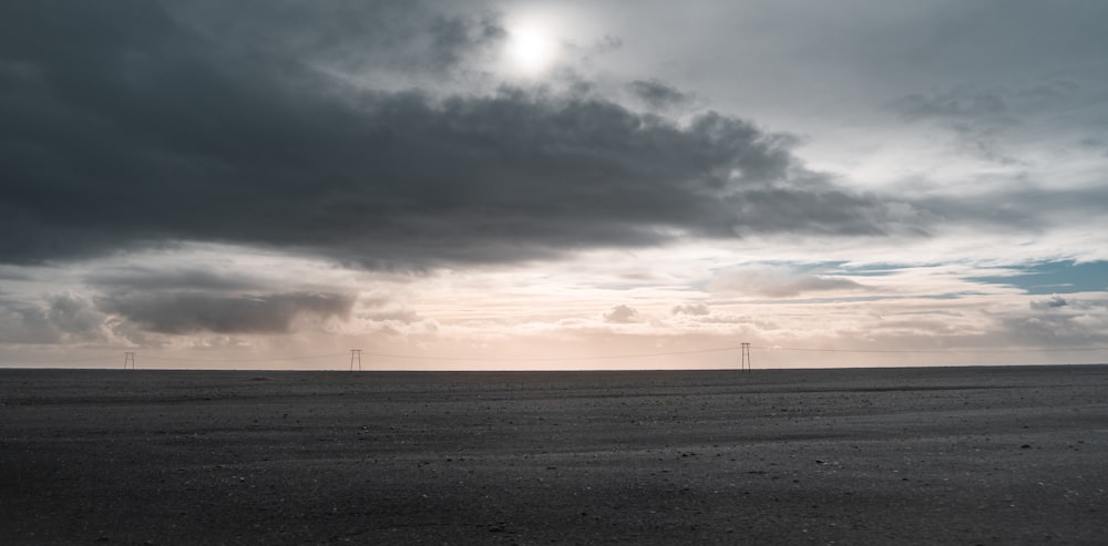 a large open field under a cloudy sky