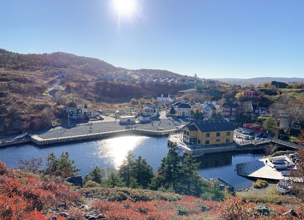 a view of a town with a lake in the foreground