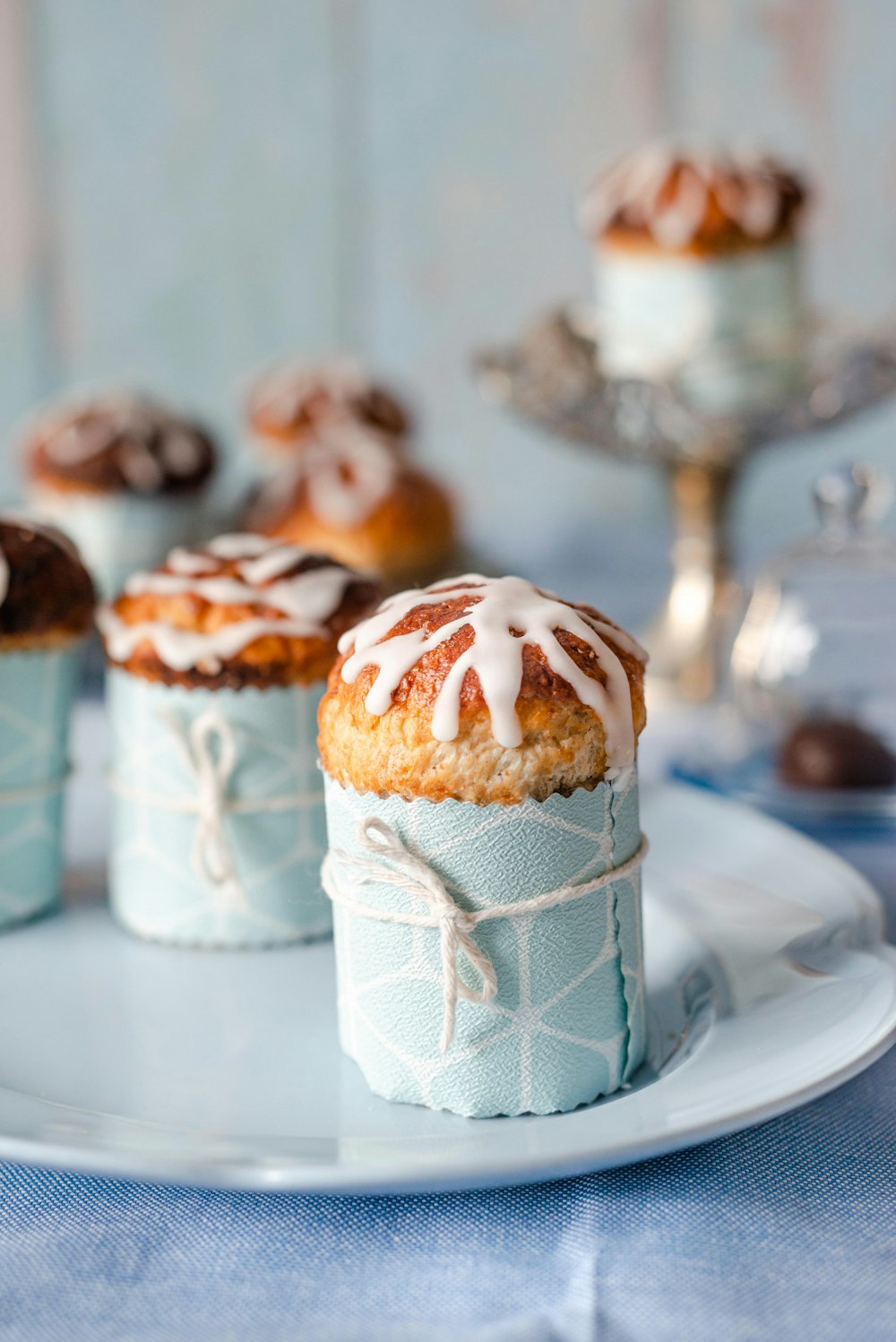 a white plate topped with cupcakes covered in icing