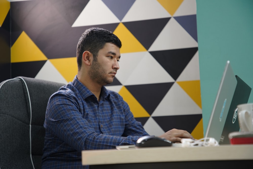 a man sitting in front of a laptop computer