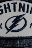 a white and blue hat with lightning on it