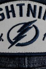 a white and blue hat with lightning on it
