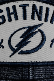 a white and blue hat with lightning on it