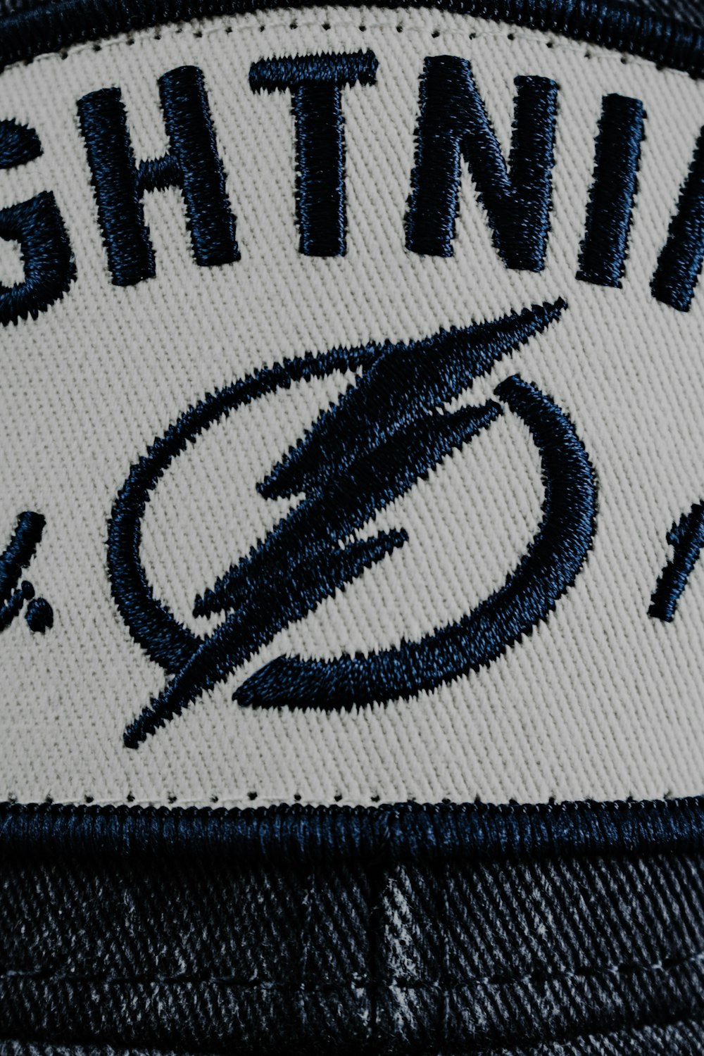 a white and blue hat with lightning on it