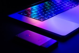 a laptop and a cell phone sitting on a table
