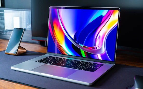 a laptop computer sitting on top of a wooden desk