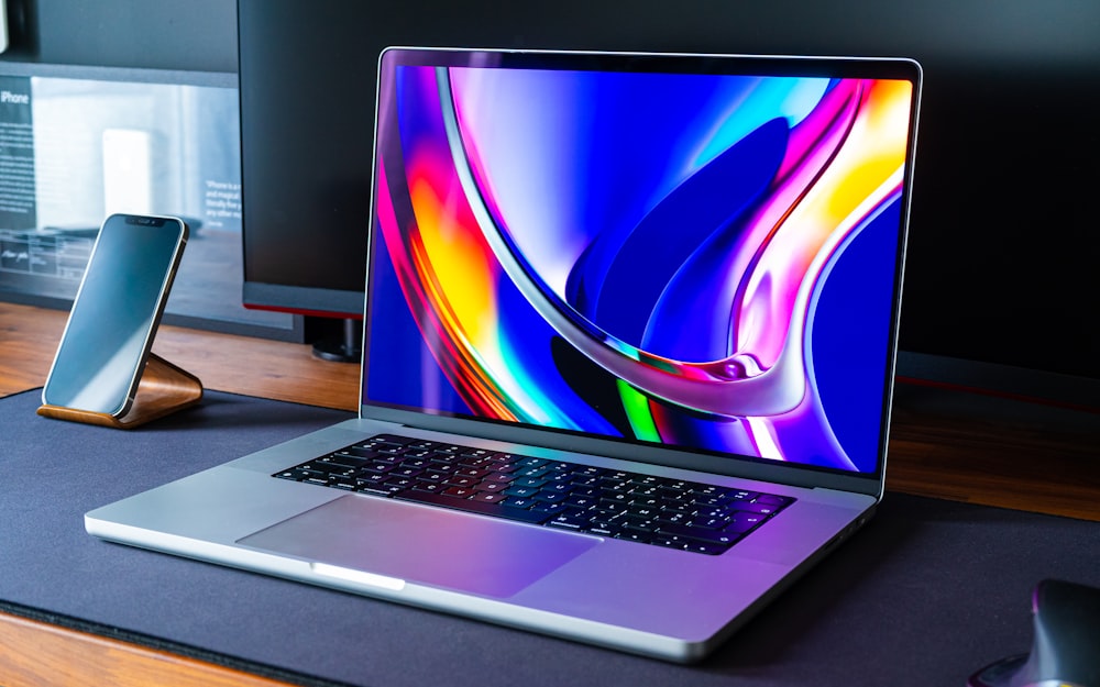 a laptop computer sitting on top of a wooden desk