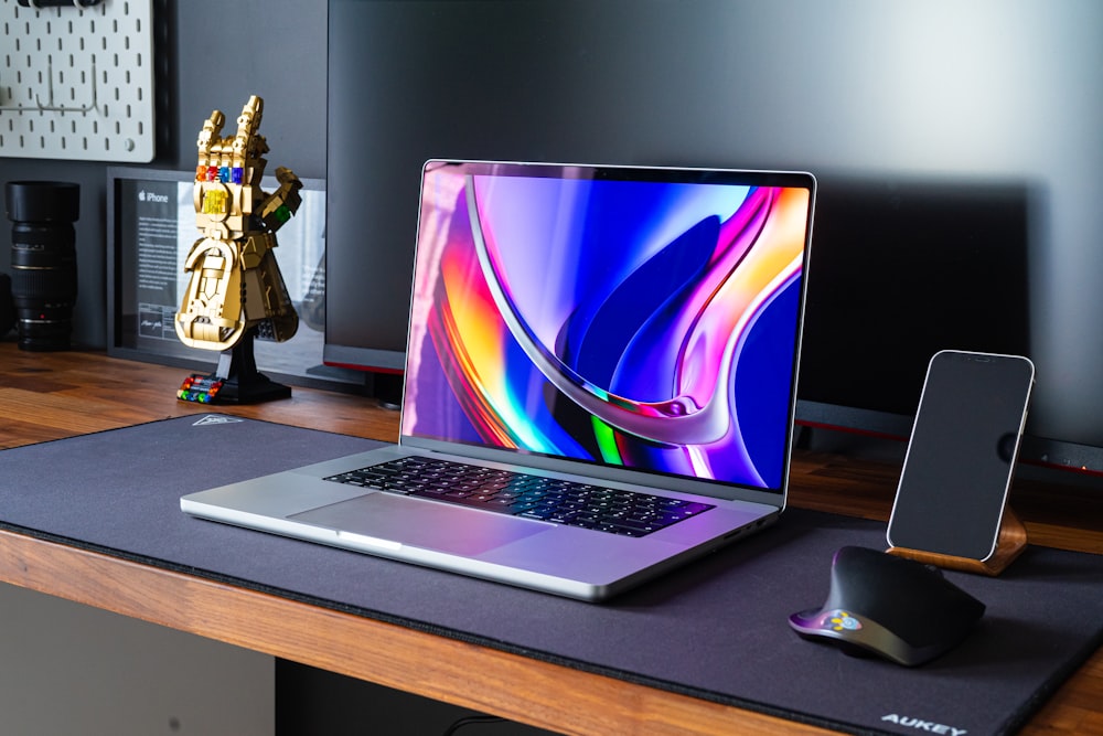 a laptop computer sitting on top of a wooden desk