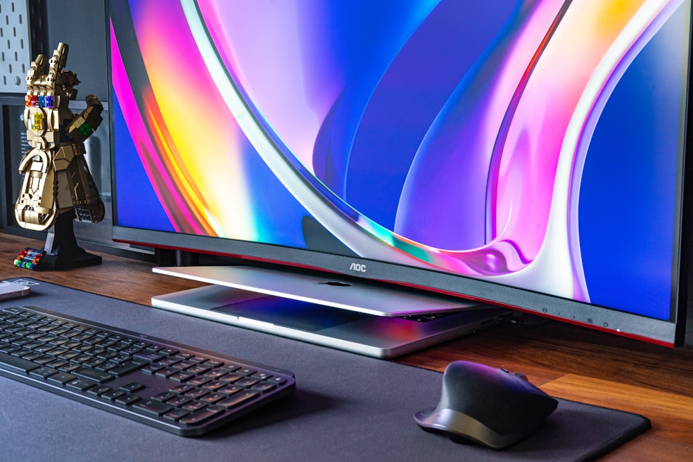 a computer monitor and keyboard on a desk