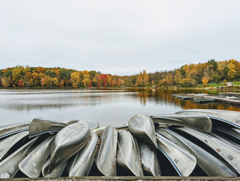 a row of canoes sitting on top of a wooden dock