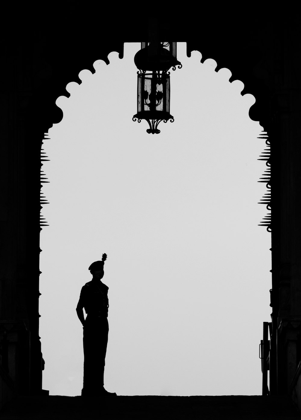a silhouette of a man standing in front of a light